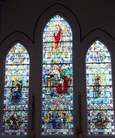 The central east window showing some events in the life of Jesus.